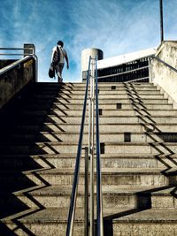 Low angle view of man standing on staircase