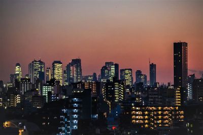 Illuminated buildings in city at night