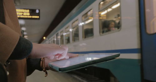 Midsection of man holding train