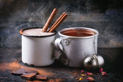 Mugs with tea and hot chocolate