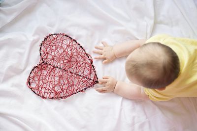 High angle view of child on bed