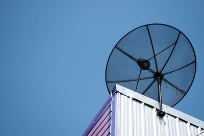 Low angle view of satellite dish against clear blue sky