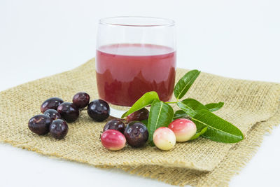 Close-up of fruits with drink on table