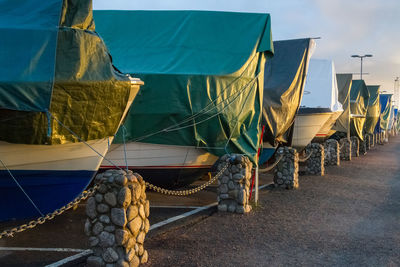 Boats moored at beach against sky