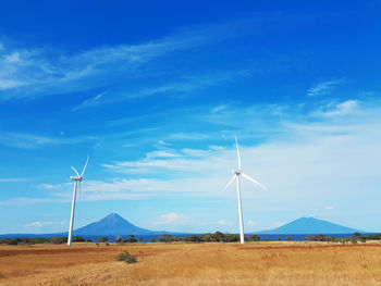 Windmill on field against sky