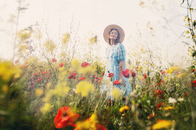 Full length of smiling girl standing on field
