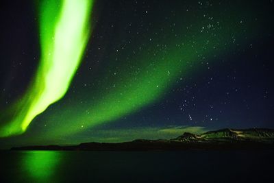 Scenic view of landscape against sky at night