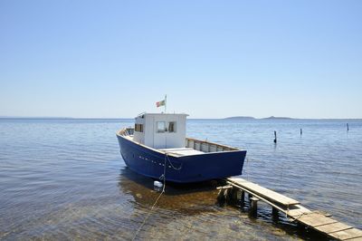 Boat on sea against clear sky