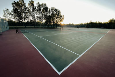 Empty tennis court at dawn