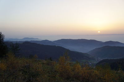 Scenic view of mountains against sky at sunset