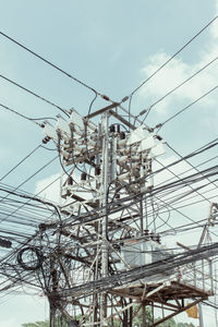 Low angle view of electricity pylon against sky