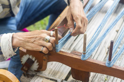 Midsection of person weaving