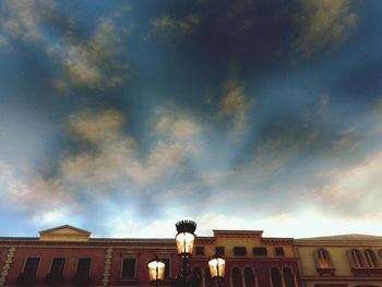 Low angle view of building against cloudy sky