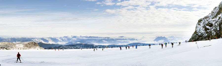 Tourists on snow covered mountain