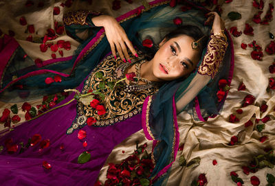 High angle view of bride lying on textile