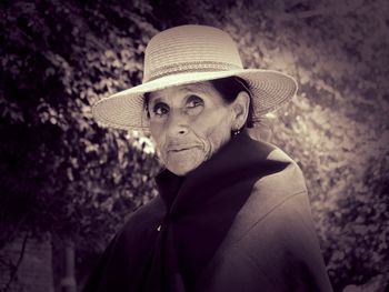 Portrait of woman wearing hat against plants