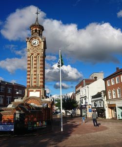 Clock tower in city against sky