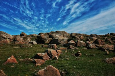 Rock formations on landscape against sky