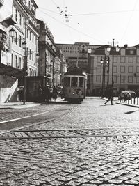 Street amidst buildings in city against sky