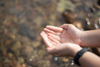 Midsection of woman hands on water