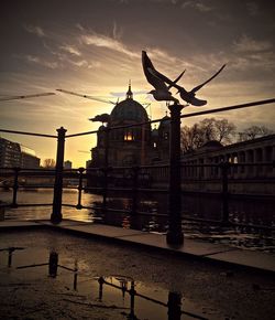 Built structures against sky at sunset