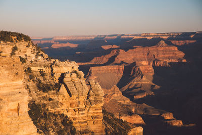 Scenic view of landscape against clear sky at grand canyon national park during sunset