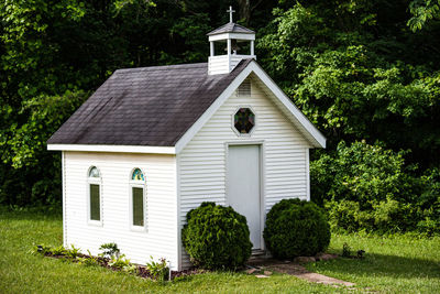 Exterior of house amidst trees and building