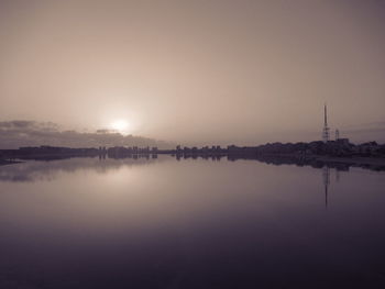 Scenic view of lake against sky during sunset