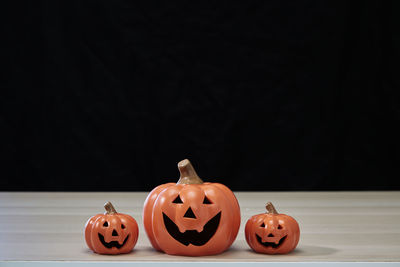 Close-up of pumpkin on table against black background