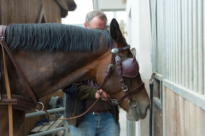 Midsection of man standing in stable