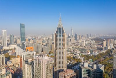 Aerial view of buildings in city against sky