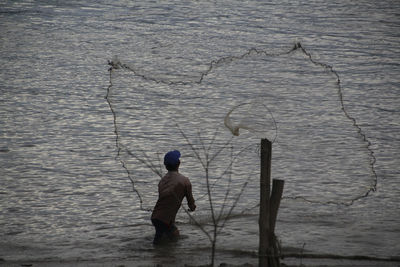 Full length of man fishing in lake