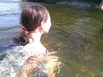 Rear view of woman swimming in sea