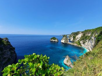 Scenic view of bay against clear blue sky