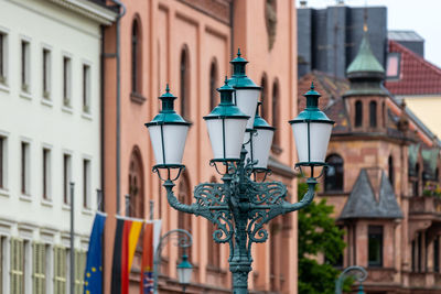 Low angle view of street light against building