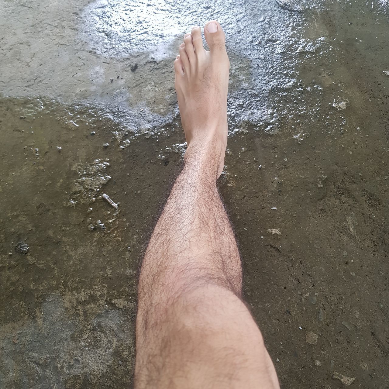 LOW SECTION OF MAN LEGS IN WATER