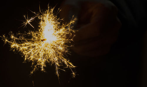 Close-up of illuminated firework display against black background