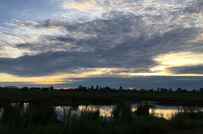 Scenic view of lake against sky during sunset