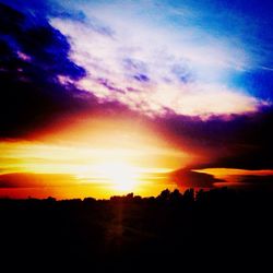 Scenic view of silhouette landscape against sky at sunset