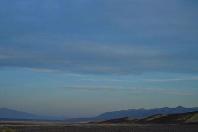 Scenic view of landscape against blue sky