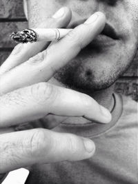 Cropped image of hand holding sunglasses