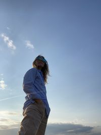 Low angle view of man standing against sky