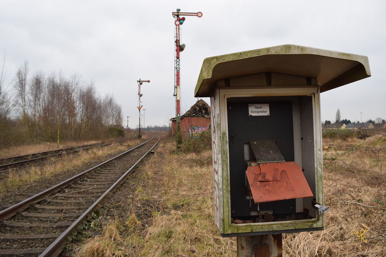 railroad track, rail transportation, transportation, field, sky, clear sky, landscape, public transportation, tree, day, rural scene, outdoors, no people, abandoned, nature, tranquility, grass, wood - material, fuel and power generation, tranquil scene