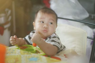 Portrait of cute baby girl on bed