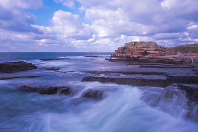 Scenic view of sea against cloudy sky
