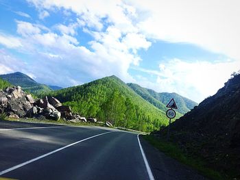Road amidst mountains against sky