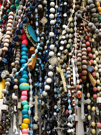 Low angle view of rosary beads hanging for sale at market