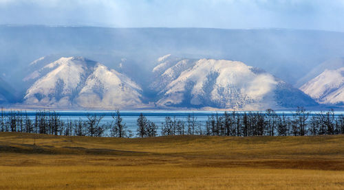 Scenic view of lake and mountains against sky