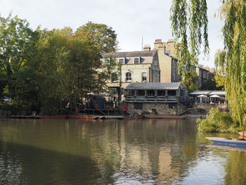 Building by river against sky