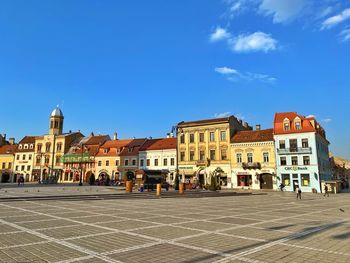 Buildings in town against blue sky
